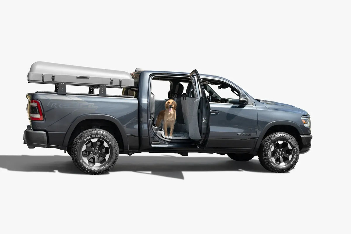Truck with the rear door open and a dog riding on a Ruff Liners cover